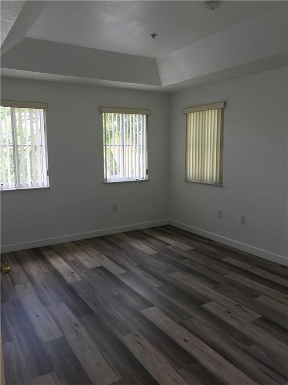 4331 Southwest 160th Avenue, Unit 200 Miramar, FL 33027 - Photo 13 of 19 a view of an empty room with wooden floor and a window