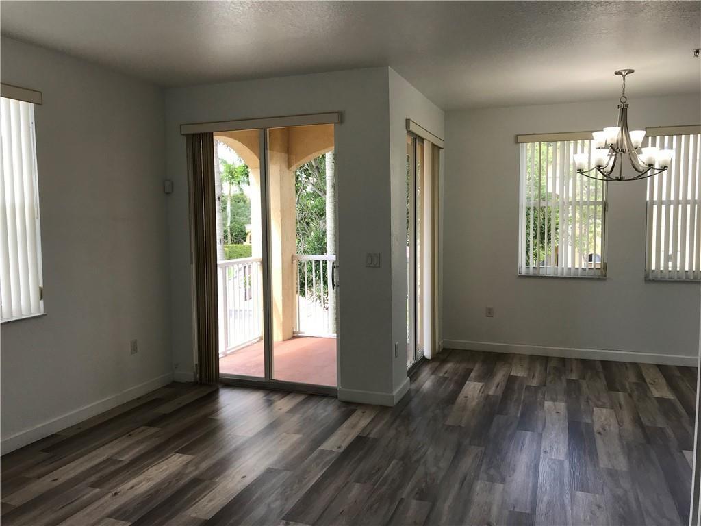 4331 Southwest 160th Avenue, Unit 200 Miramar, FL 33027 - Photo 4 of 19 an empty room with wooden floor and windows