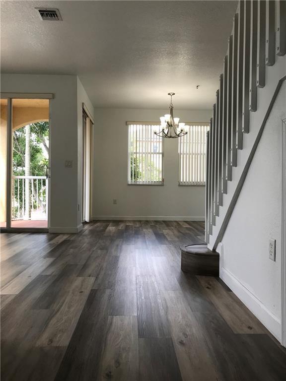4331 Southwest 160th Avenue, Unit 200 Miramar, FL 33027 - Photo 5 of 19 an empty room with wooden floor and windows