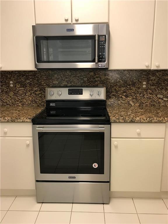 4331 Southwest 160th Avenue, Unit 200 Miramar, FL 33027 - Photo 9 of 19 a stove top oven sitting inside of a kitchen