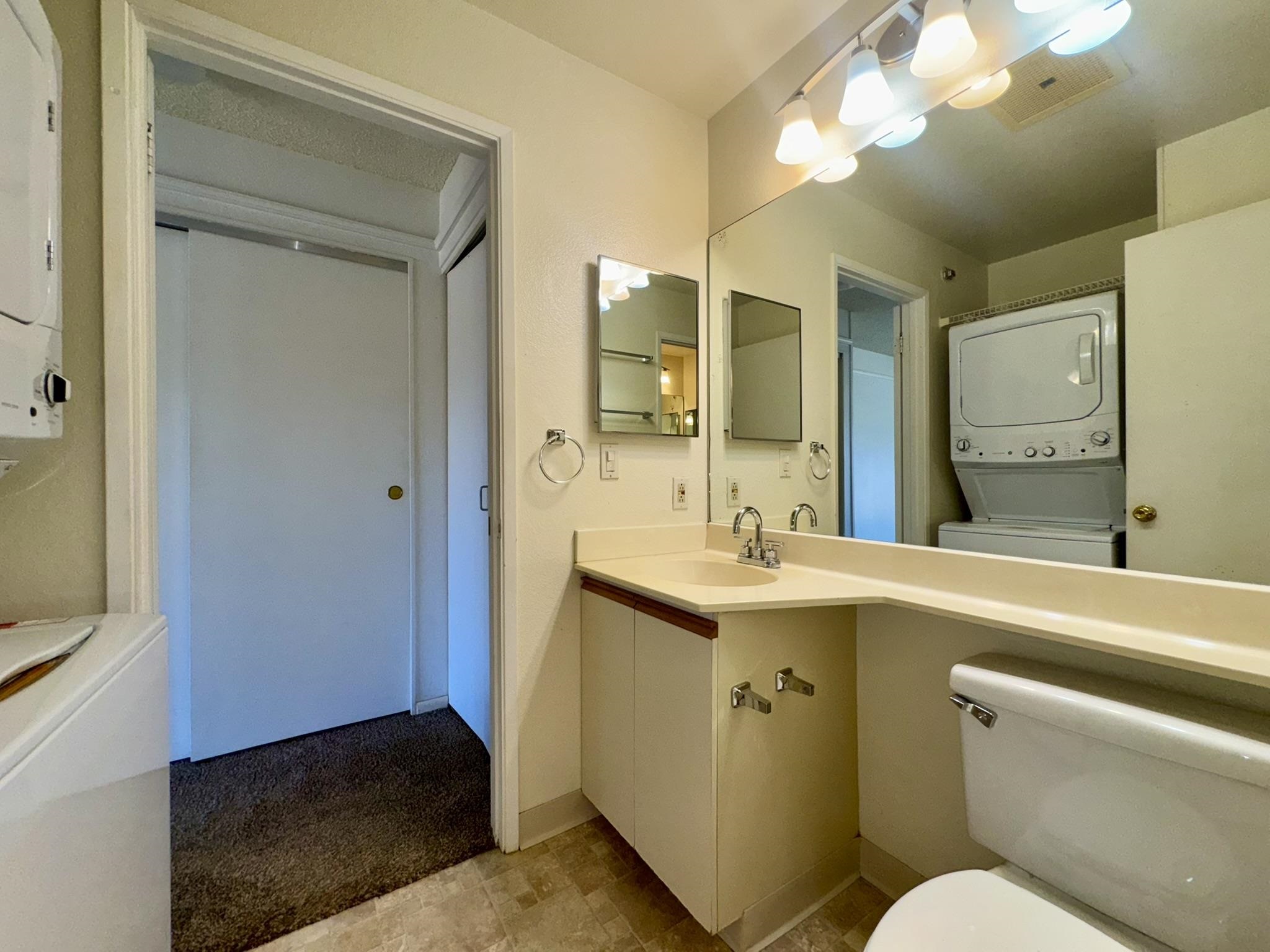 140 Uwapo Road, Unit 56204 Kihei, HI 96753 - Photo 16 of 40 a bathroom with a sink a toilet and a mirror