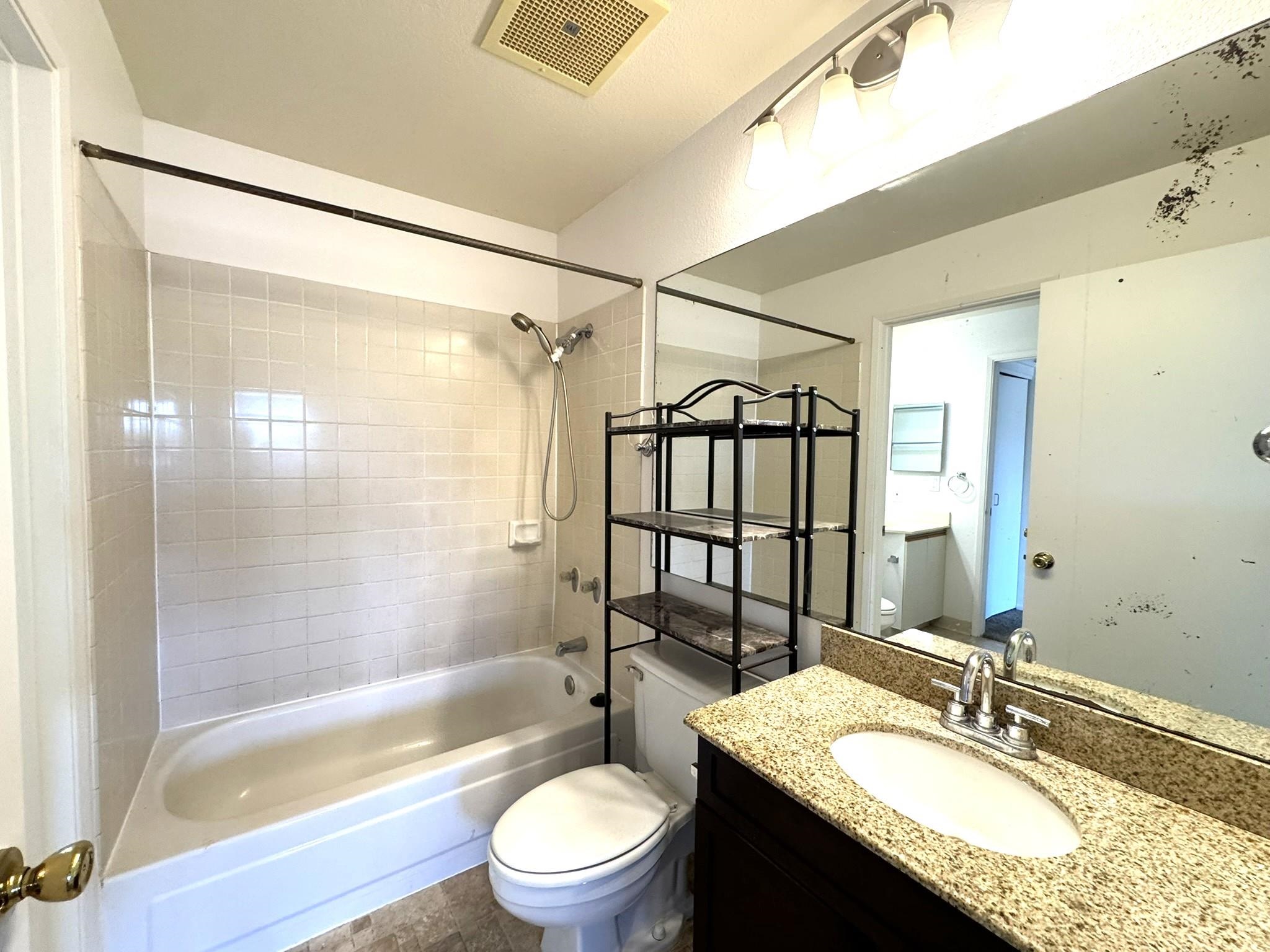140 Uwapo Road, Unit 56204 Kihei, HI 96753 - Photo 18 of 40 a bathroom with a granite countertop sink toilet tub and shower