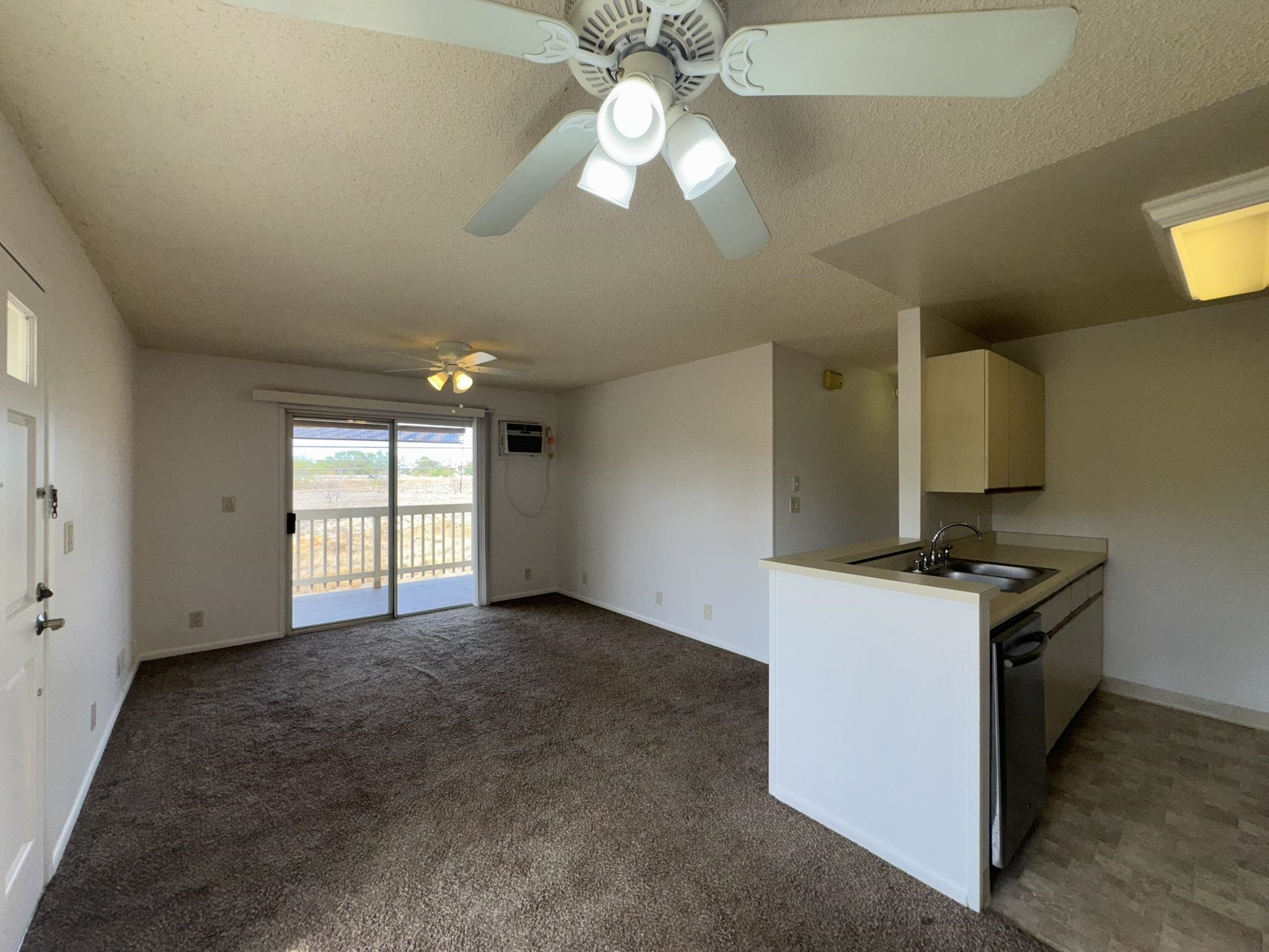 140 Uwapo Road, Unit 56204 Kihei, HI 96753 - Photo 3 of 40 a view of a kitchen with a stove cabinets and a large window