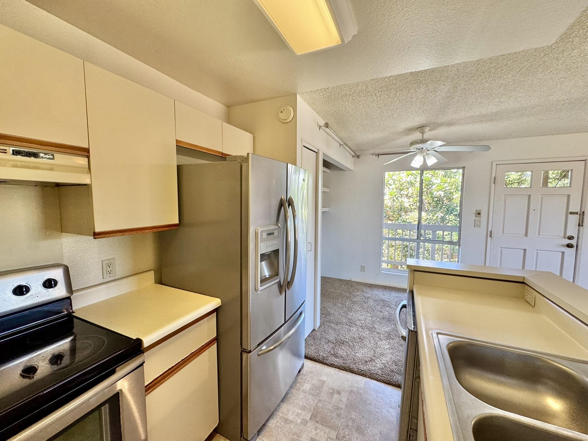 140 Uwapo Road, Unit 56204 Kihei, HI 96753 - Photo 7 of 40 a kitchen with a refrigerator sink and stove