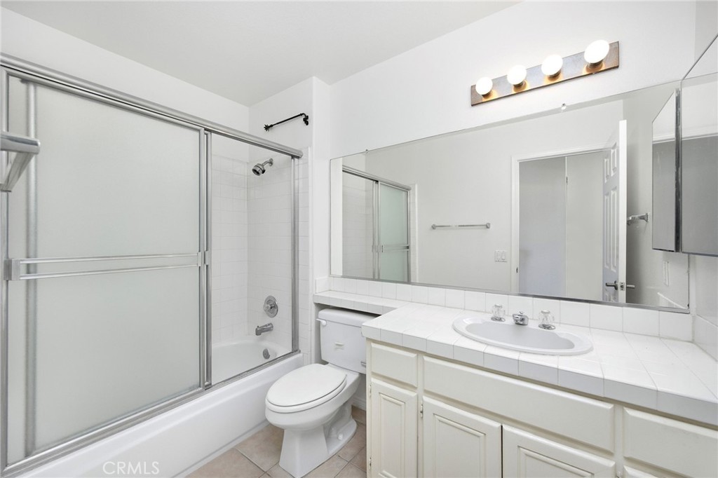 33072 Ocean Ridge Dana Point, CA 92629 - Photo 19 of 26 a bathroom with a sink a toilet a large mirror and shower