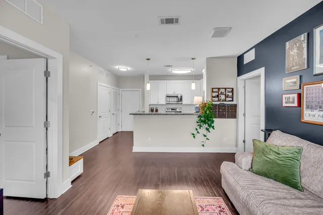 a living room with furniture and wooden floor