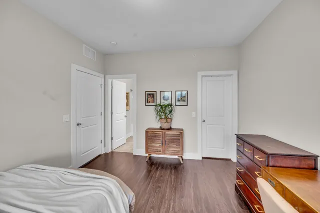 a bedroom with a bed and wooden floor
