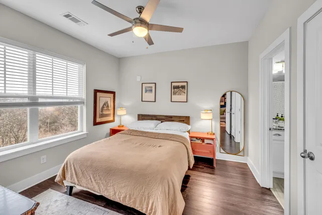 a bedroom with a bed and a large window