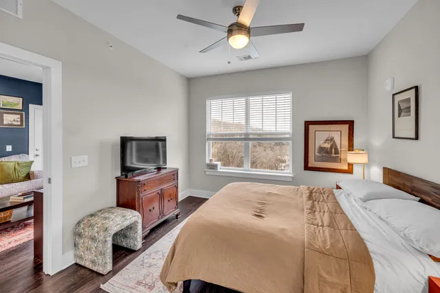 a bedroom with furniture and a flat screen tv