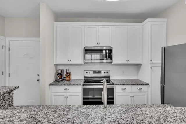 a kitchen with appliances cabinets and a counter top space