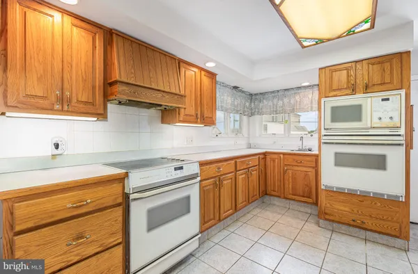 a kitchen with a stove sink and cabinets