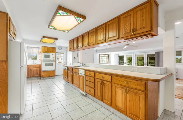 a view of a kitchen with a sink and dishwasher with a large window