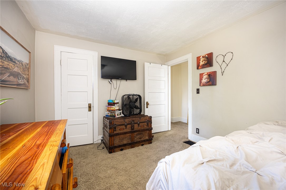 540 Cambridge Road Coshocton, OH 43812 - Photo 19 of 38 Bedroom featuring light carpet and a textured ceiling