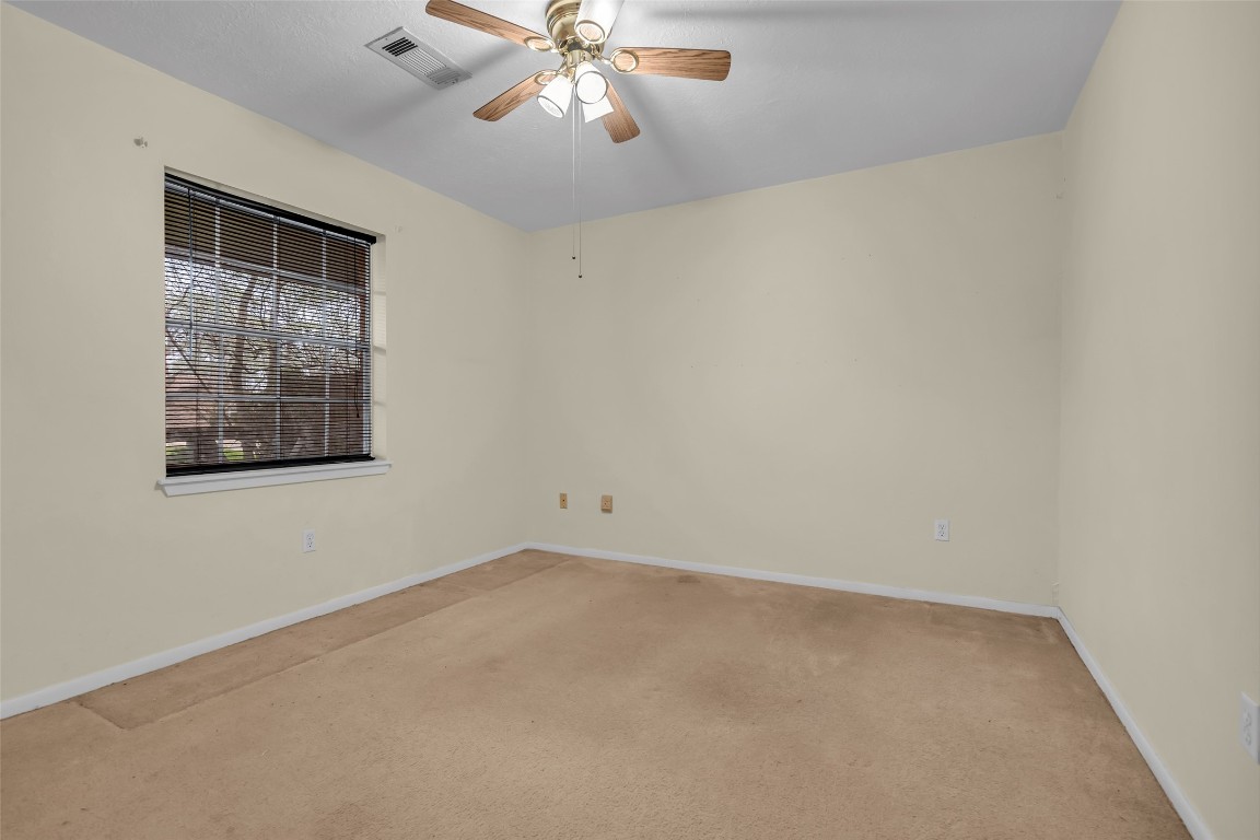 10002 Pinehurst Street Baytown, TX 77521 - Photo 13 of 17 an empty room with a window