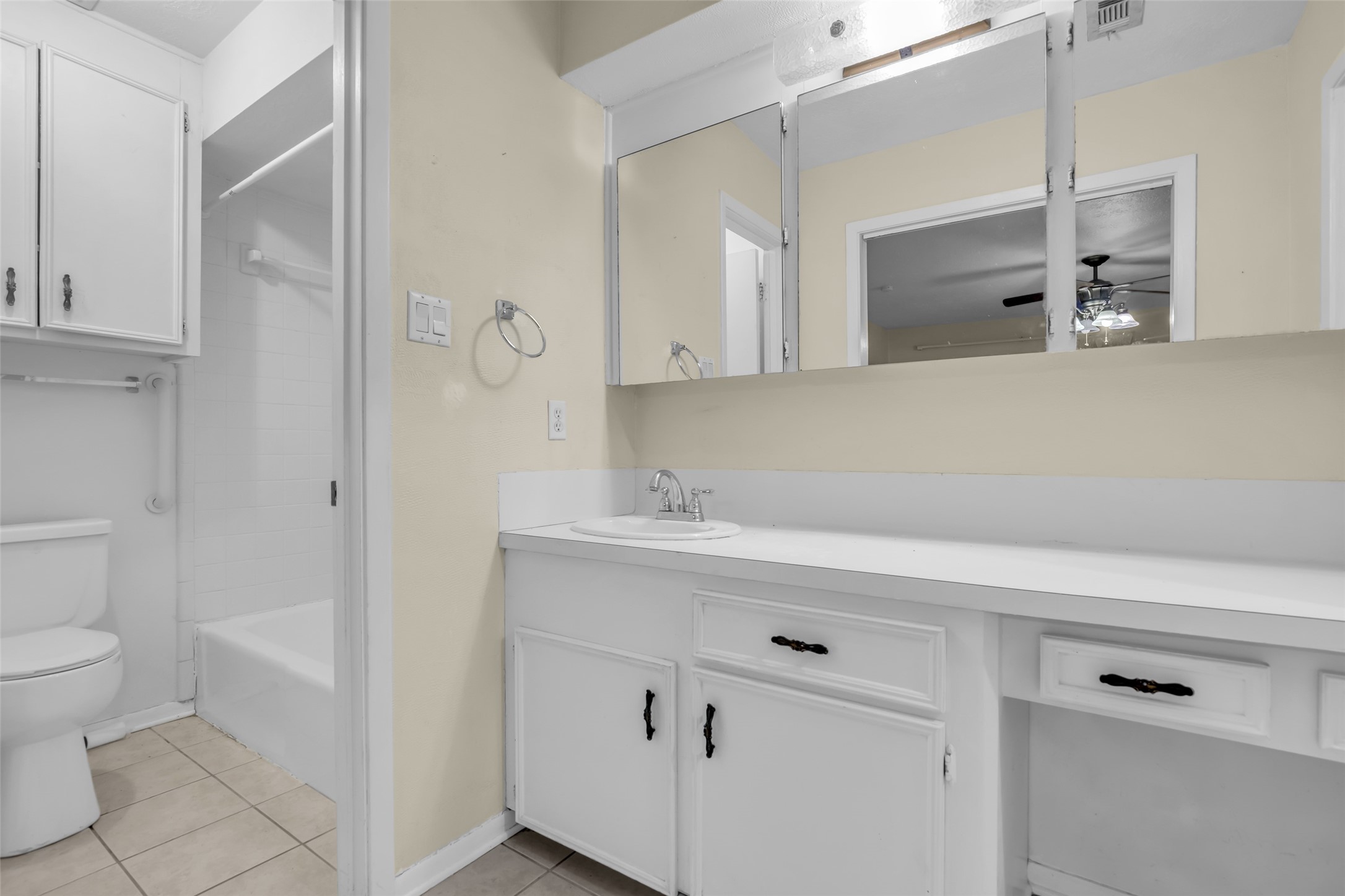 10002 Pinehurst Street Baytown, TX 77521 - Photo 15 of 17 a bathroom with a sink a toilet and a mirror