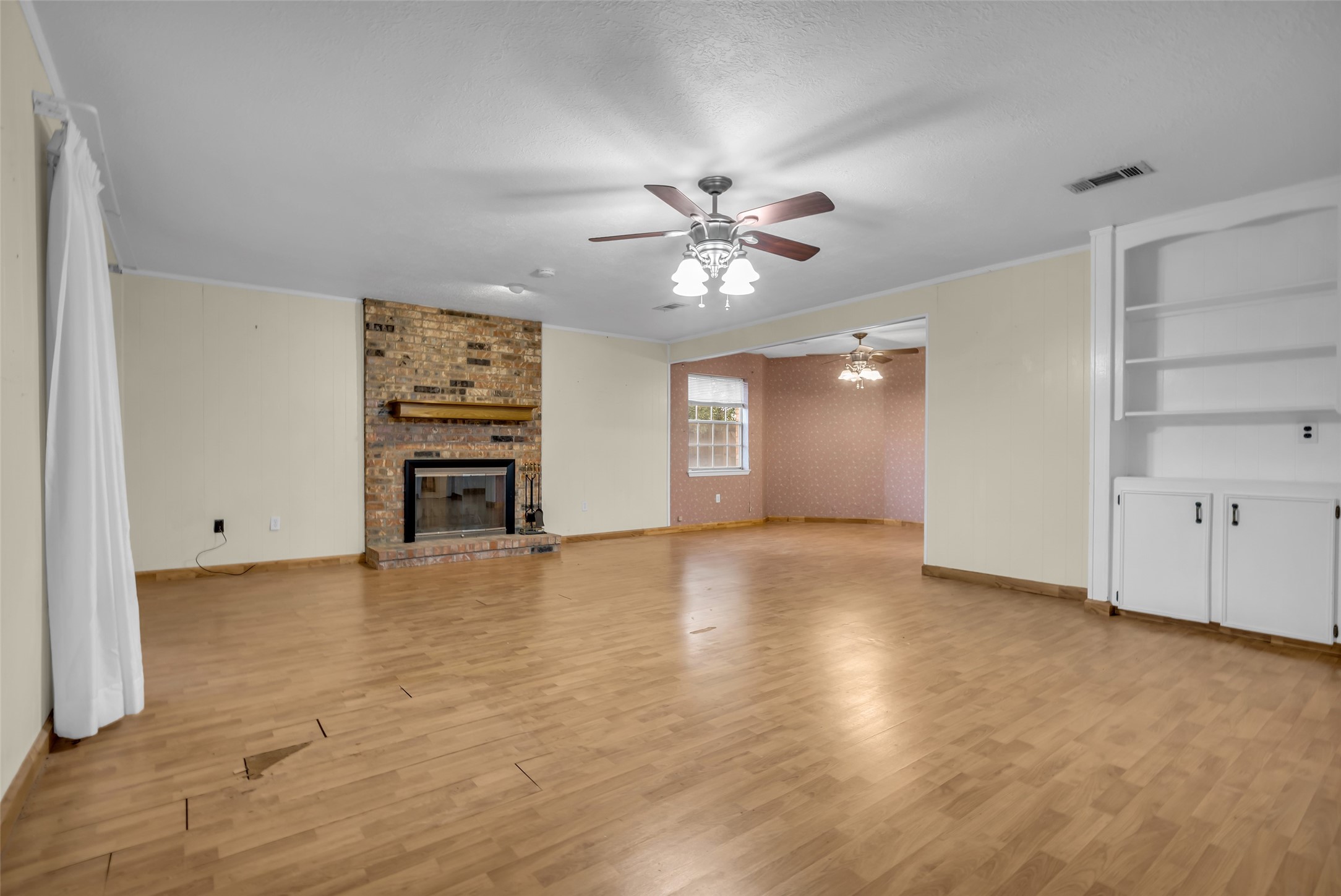 10002 Pinehurst Street Baytown, TX 77521 - Photo 6 of 17 wooden floor in an empty room with a window