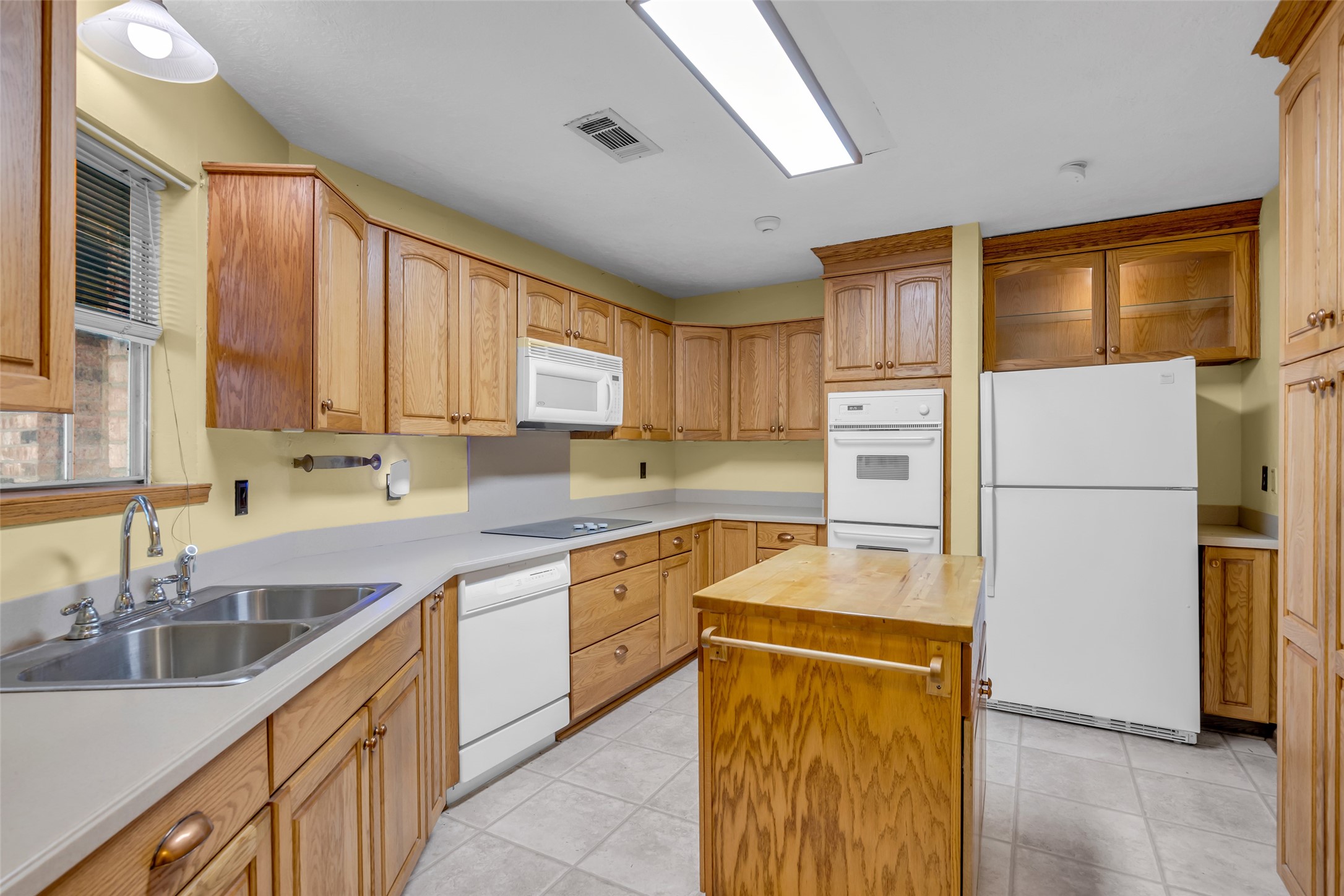 10002 Pinehurst Street Baytown, TX 77521 - Photo 7 of 17 a kitchen with a refrigerator sink and cabinets