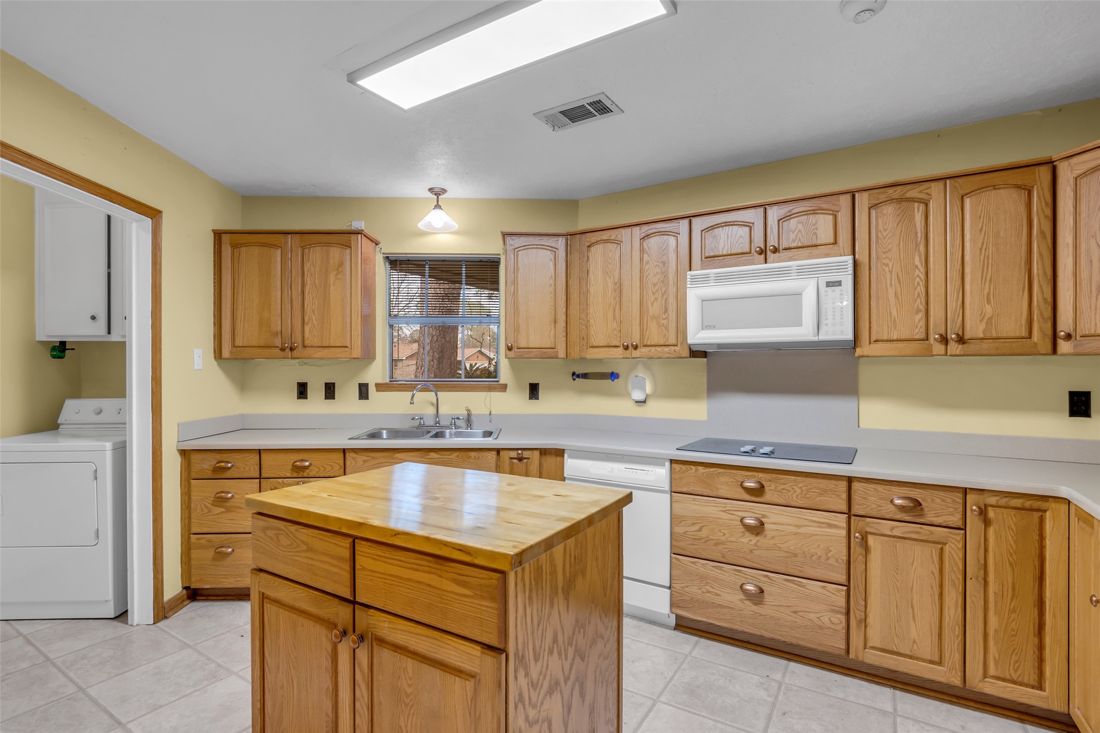 10002 Pinehurst Street Baytown, TX 77521 - Photo 8 of 17 a kitchen with kitchen island granite countertop a sink window and cabinets