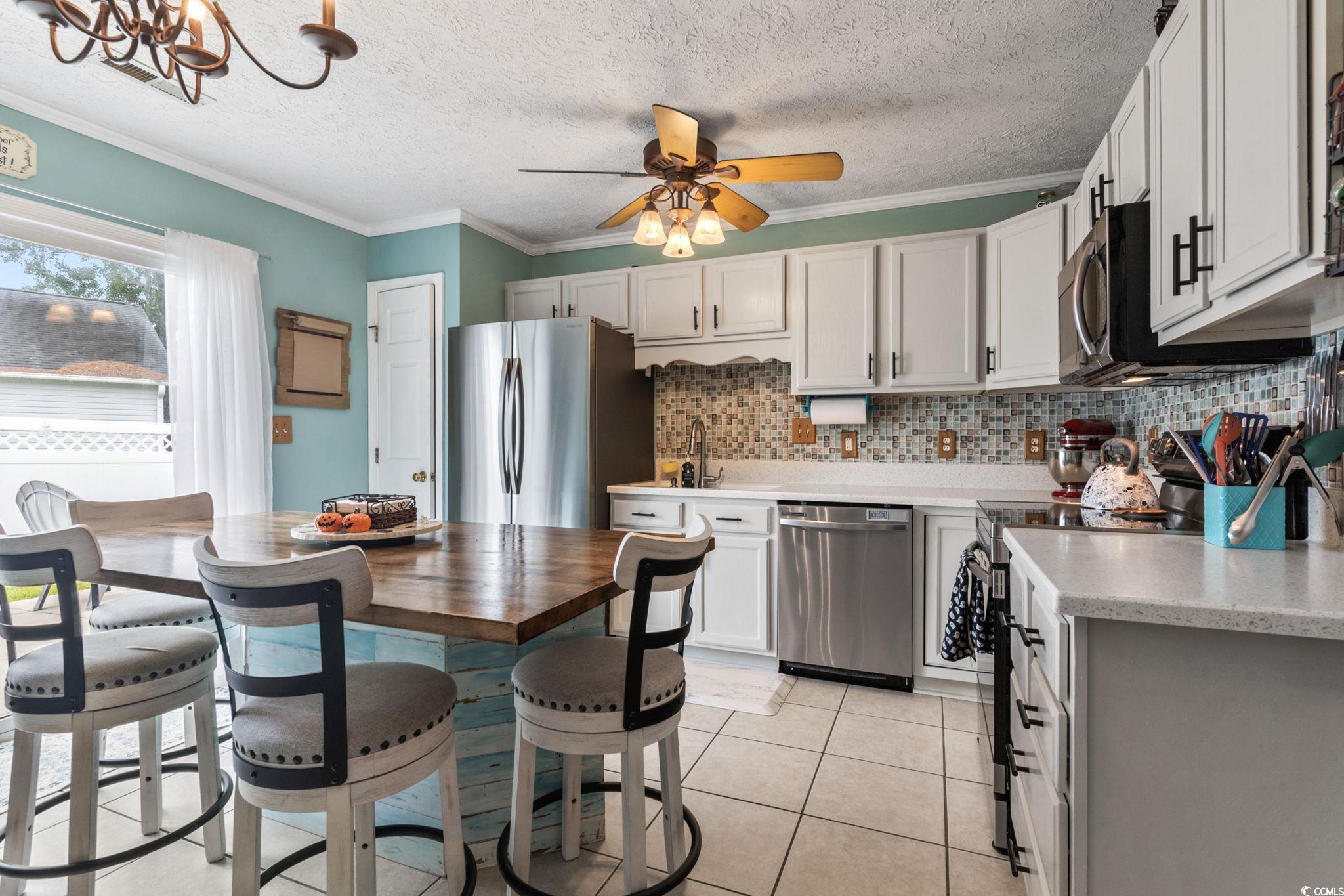 8032 Resin Road Murrells Inlet, SC 29576 - Photo 13 of 37 Kitchen with ceiling fan with notable chandelier,