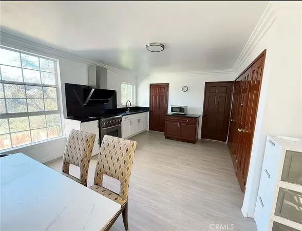 a living room with furniture a flat screen tv and large window