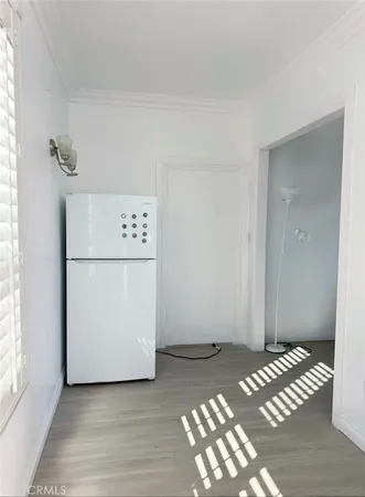 a view of a bedroom with wooden floor