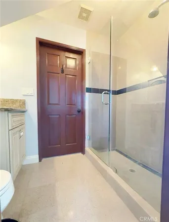 a bathroom with a shower and a sink