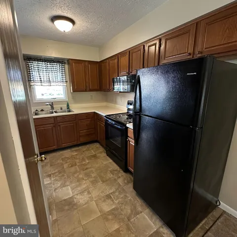 a kitchen with a refrigerator and a stove