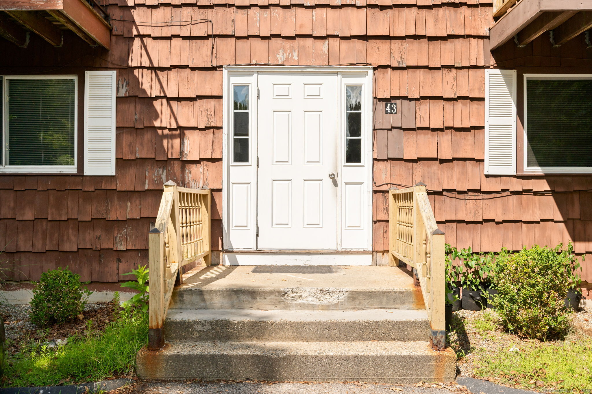 43 George Avenue, Unit 1 Groton, CT 06340 - Photo 1 of 1 a front view of a house with a garden