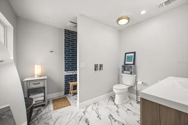 a bathroom with a toilet sink and shower