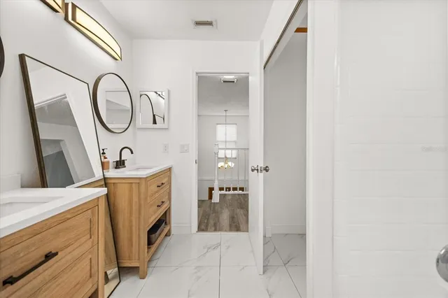 a spacious bathroom with a double vanity sink and a mirror