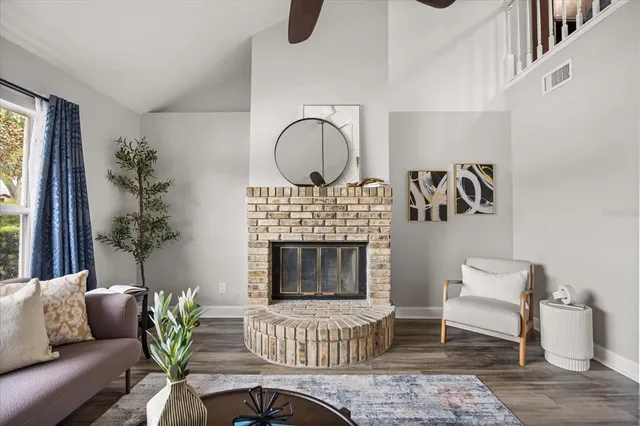 a living room with furniture a window and a fireplace