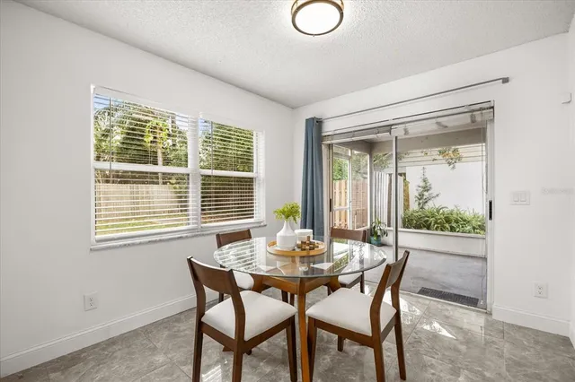 a dining room with furniture and window