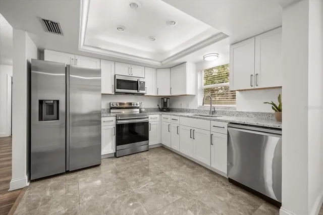 a kitchen with a refrigerator sink and microwave