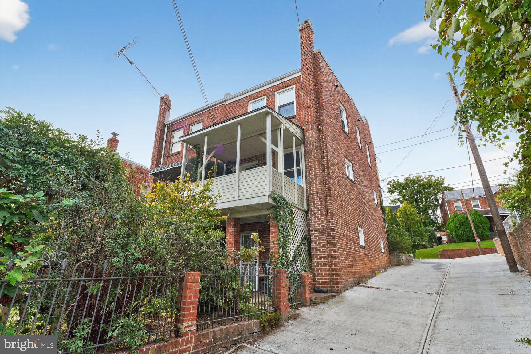 3910 R Street Southeast Washington, DC 20020 - Photo 24 of 24 Charming brick home with lush greenery.