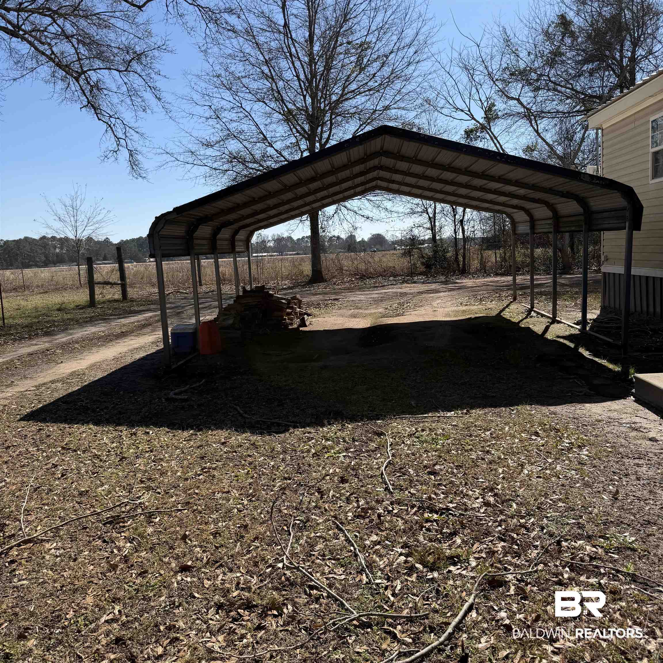 447 Sugar Hill Road Monroeville, AL 36460 - Photo 24 of 27 View of parking featuring a carport
