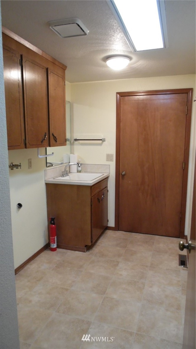 4538 180th Way Southwest Rochester, WA 98579 - Photo 14 of 25 a bathroom with a sink and mirror