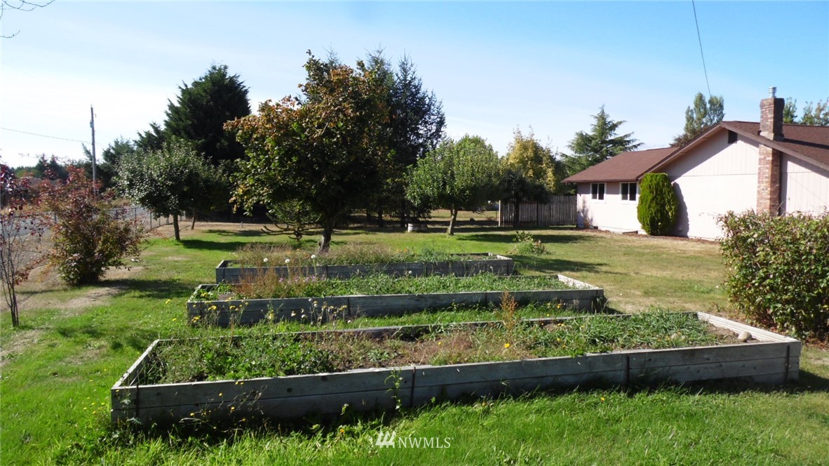 4538 180th Way Southwest Rochester, WA 98579 - Photo 17 of 25 a view of a backyard with wooden fence