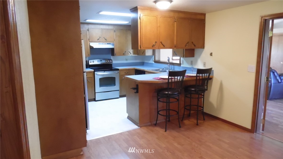 4538 180th Way Southwest Rochester, WA 98579 - Photo 3 of 25 a kitchen with a sink cabinets and counter top space