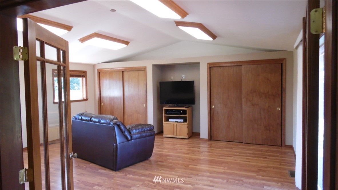 4538 180th Way Southwest Rochester, WA 98579 - Photo 5 of 25 a living room with furniture and a flat screen tv