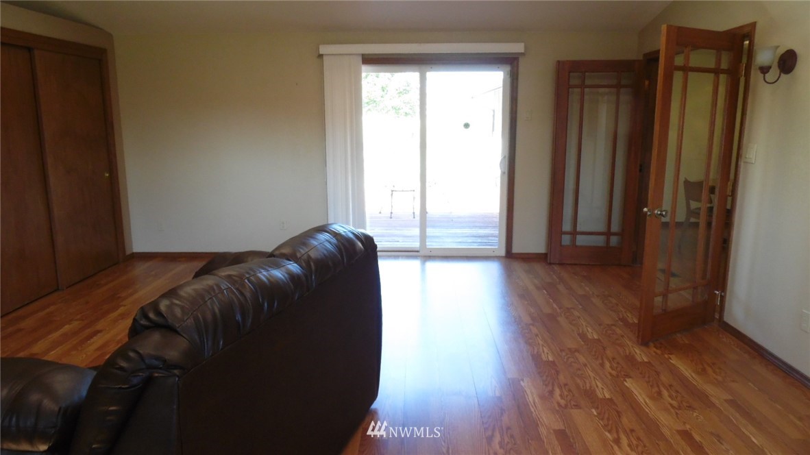 4538 180th Way Southwest Rochester, WA 98579 - Photo 7 of 25 a room with a closet and wooden floor