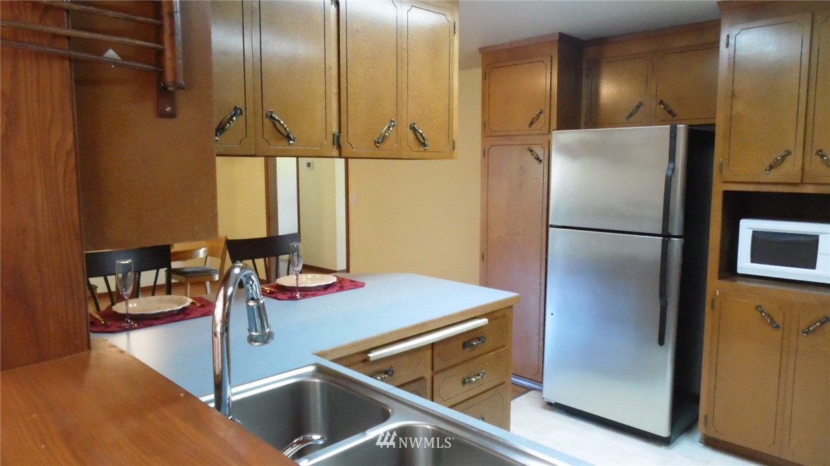 4538 180th Way Southwest Rochester, WA 98579 - Photo 8 of 25 a kitchen with stainless steel appliances granite countertop a refrigerator and a sink