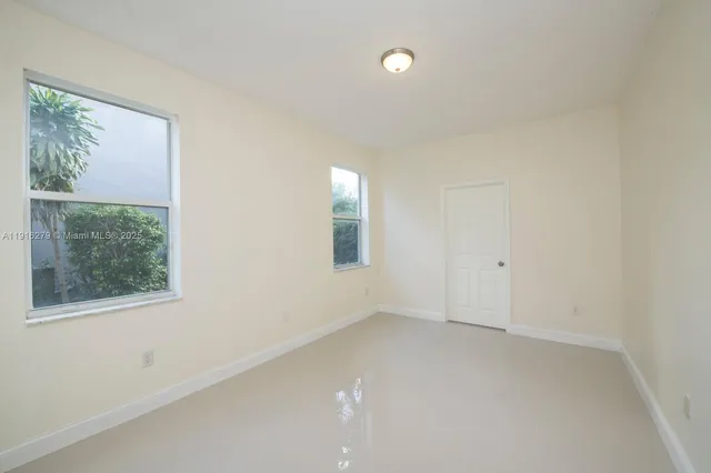 a bathroom with a toilet sink and a large mirror