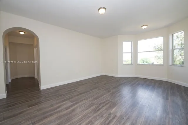 a room with a window and a dresser