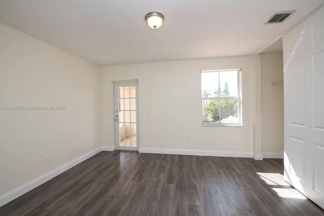 a view of a livingroom with white cabinets