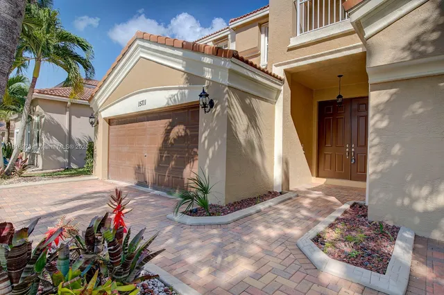 a view of a house with potted plants