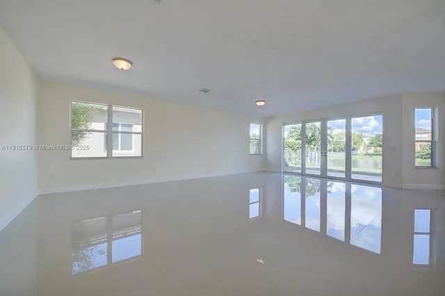 a view of kitchen with stainless steel appliances refrigerator oven and cabinets