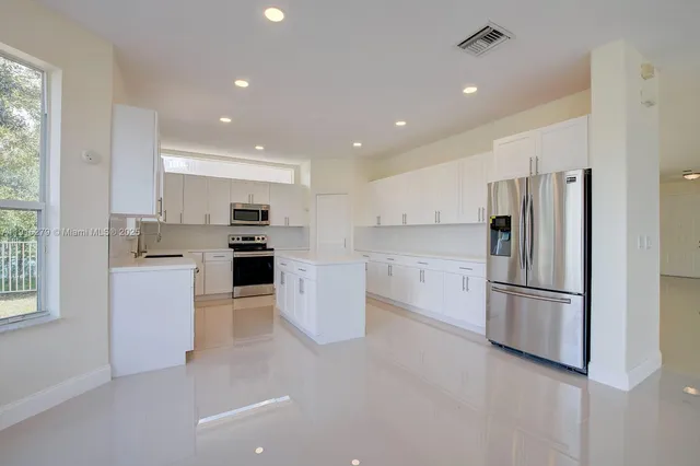 a kitchen with a sink stove and microwave
