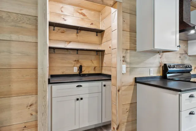 a kitchen with stainless steel appliances granite countertop white cabinets and a sink