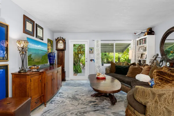 a dining room with furniture a chandelier and window