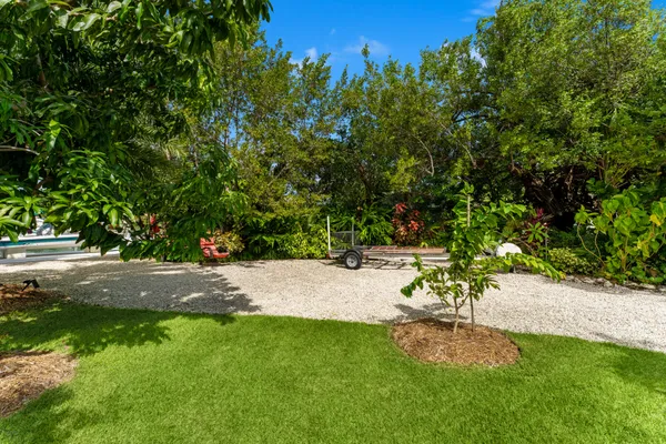 an aerial view of a house with garden space and street view